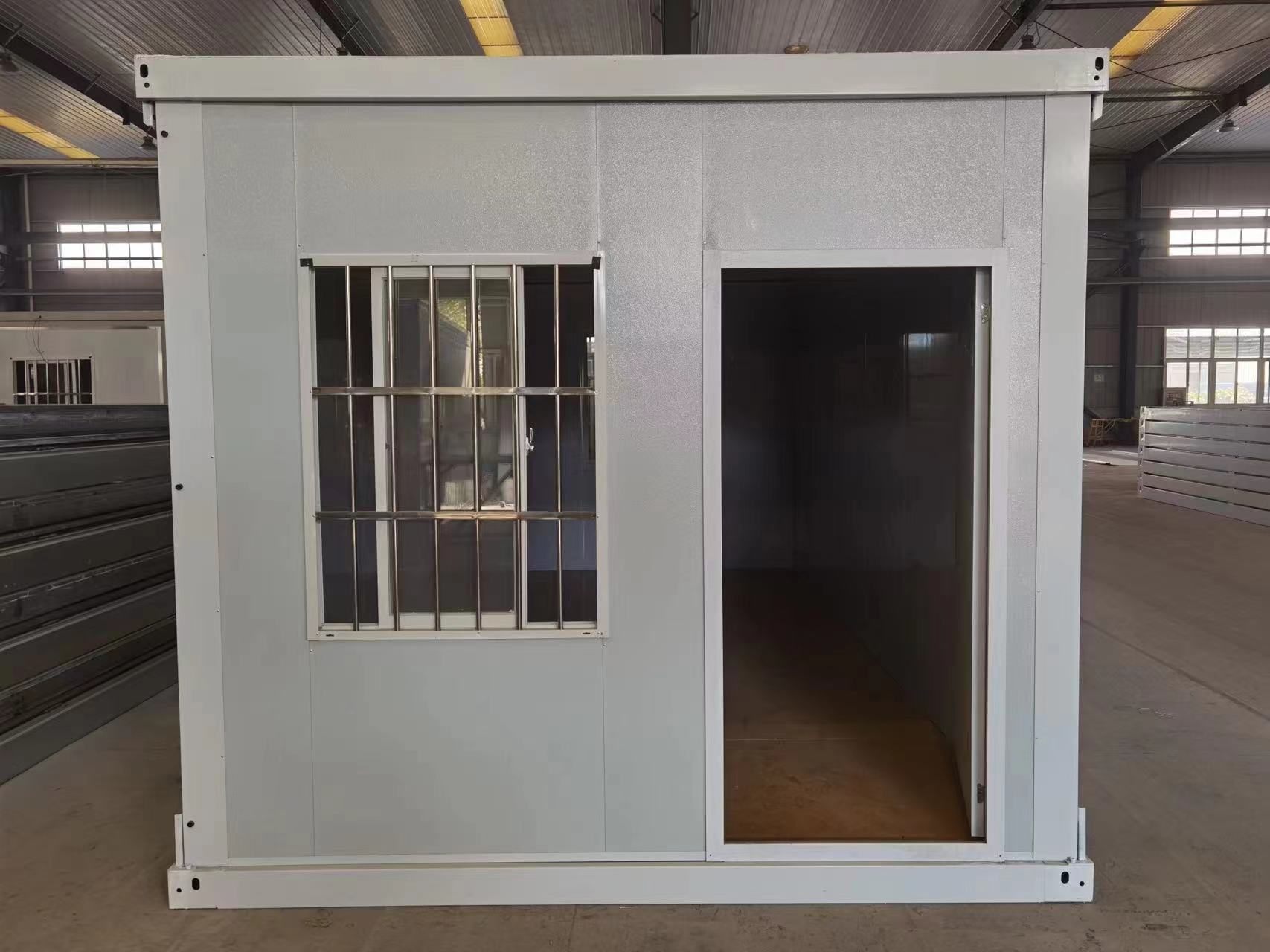 Completed folding container room with a door and security window