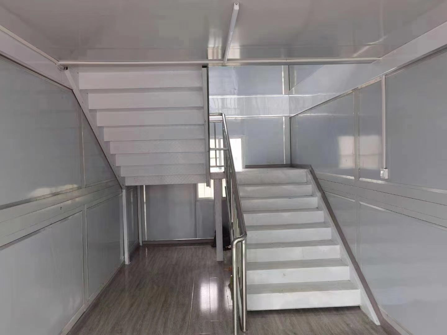 Interior staircase connecting two levels of a modular building