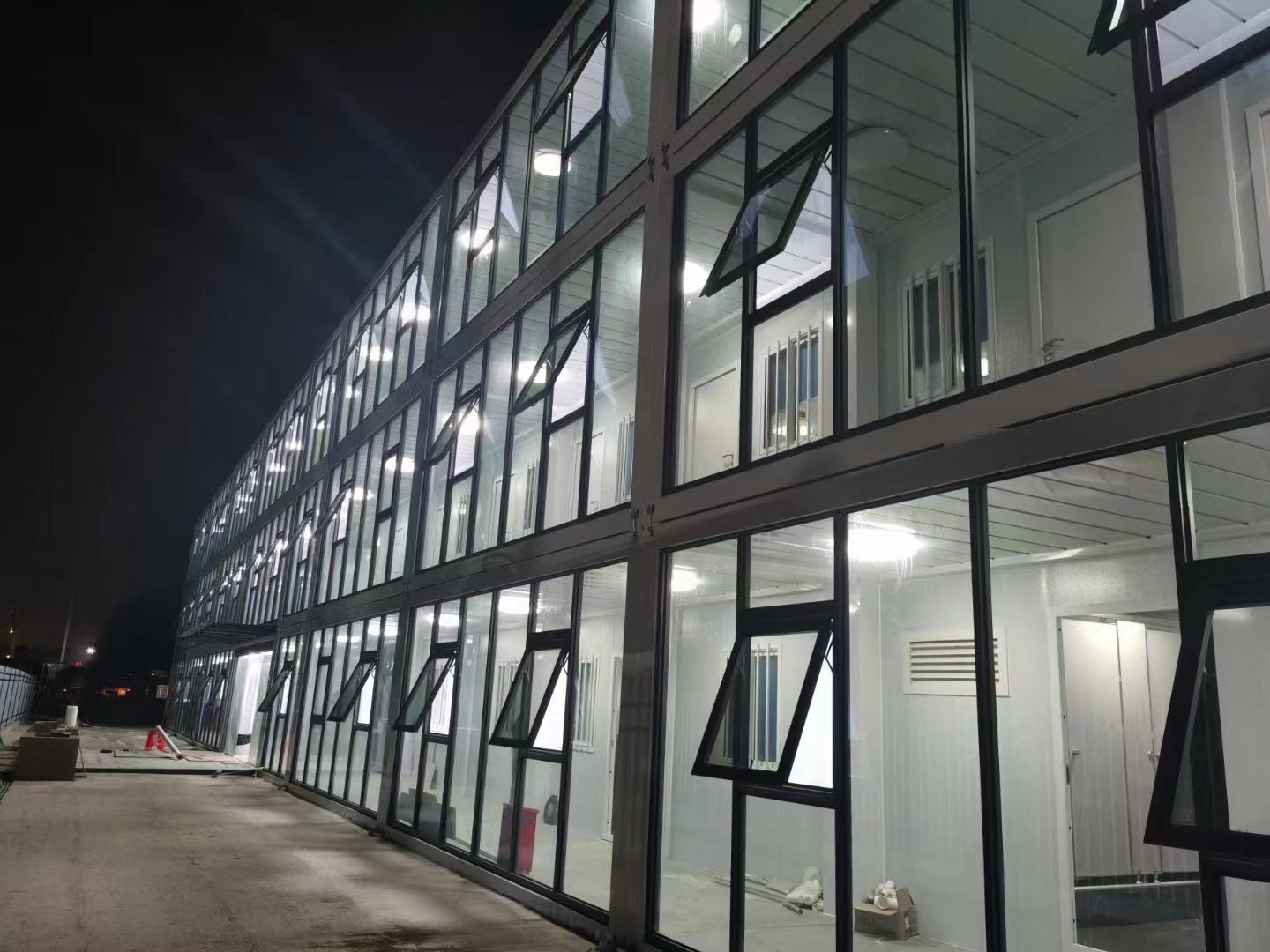 Night view of a completed two-storey glazed modular office